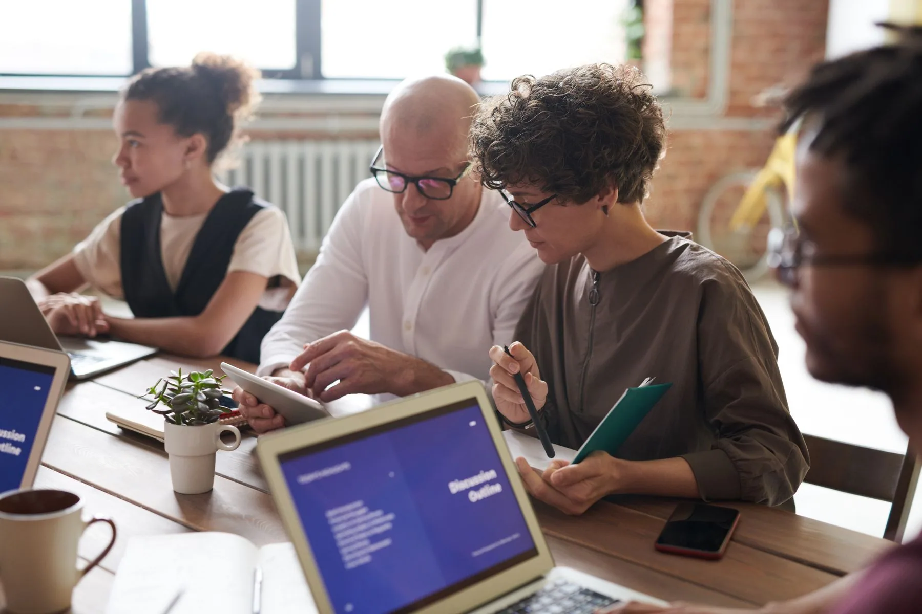 A business-casual team planning together around a meeting table